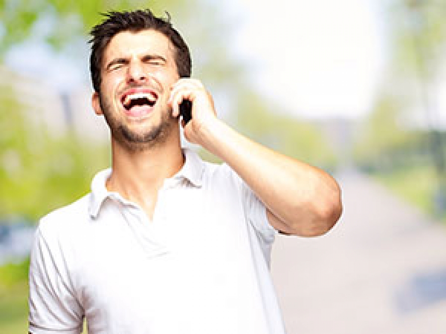 Man speaking by the phone and laughing